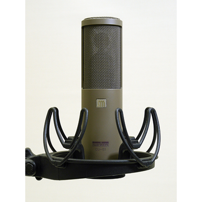 This is a photo of the Sanken CU-51. It is shown in a grey colour, in a front facing view. It is held in place by a black piece of equipment.
