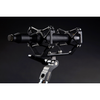 This is a photo of the CO-100K Sanken microphone. The microphone is black and on a side view held up with another piece of black equipment. It is on a black background.