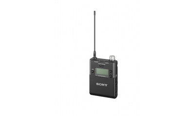 This is a photo of the SONY UTX-B03HR. It is a transmitter that you plug a microphone in to. It is black in colour with a screen on the front. It has an antenna coming off the top. It is at a front facing view. 